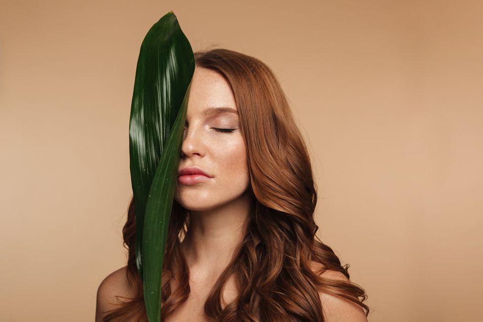 beauty-portrait-sensual-ginger-woman-with-long-hair-posing-with-green-leaf (1).jpg